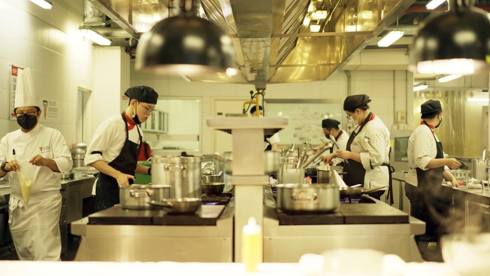 ADC students preparing meals in the kitchen.